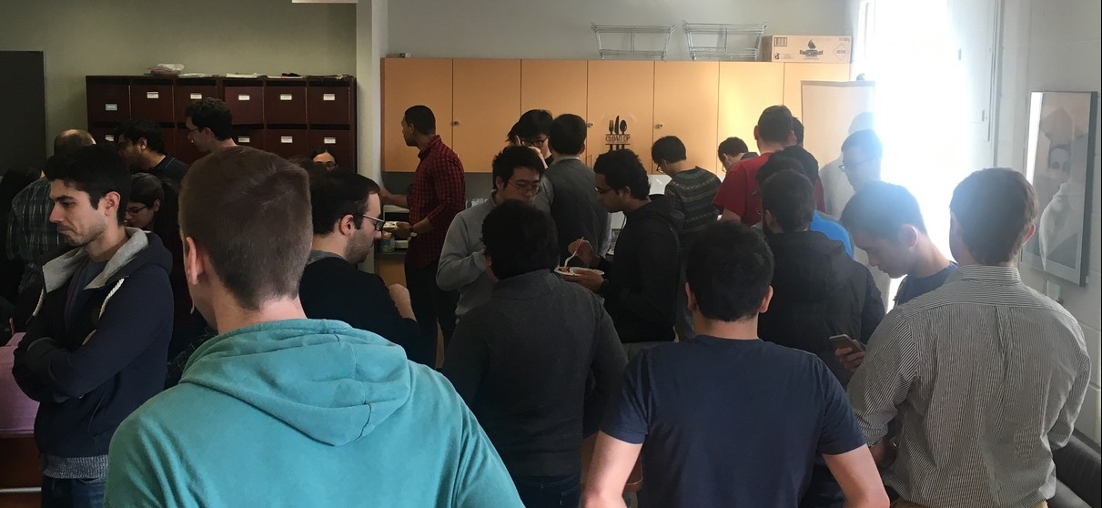 Graduate electrical engineering students lining up for refreshments during a mid-semester study break