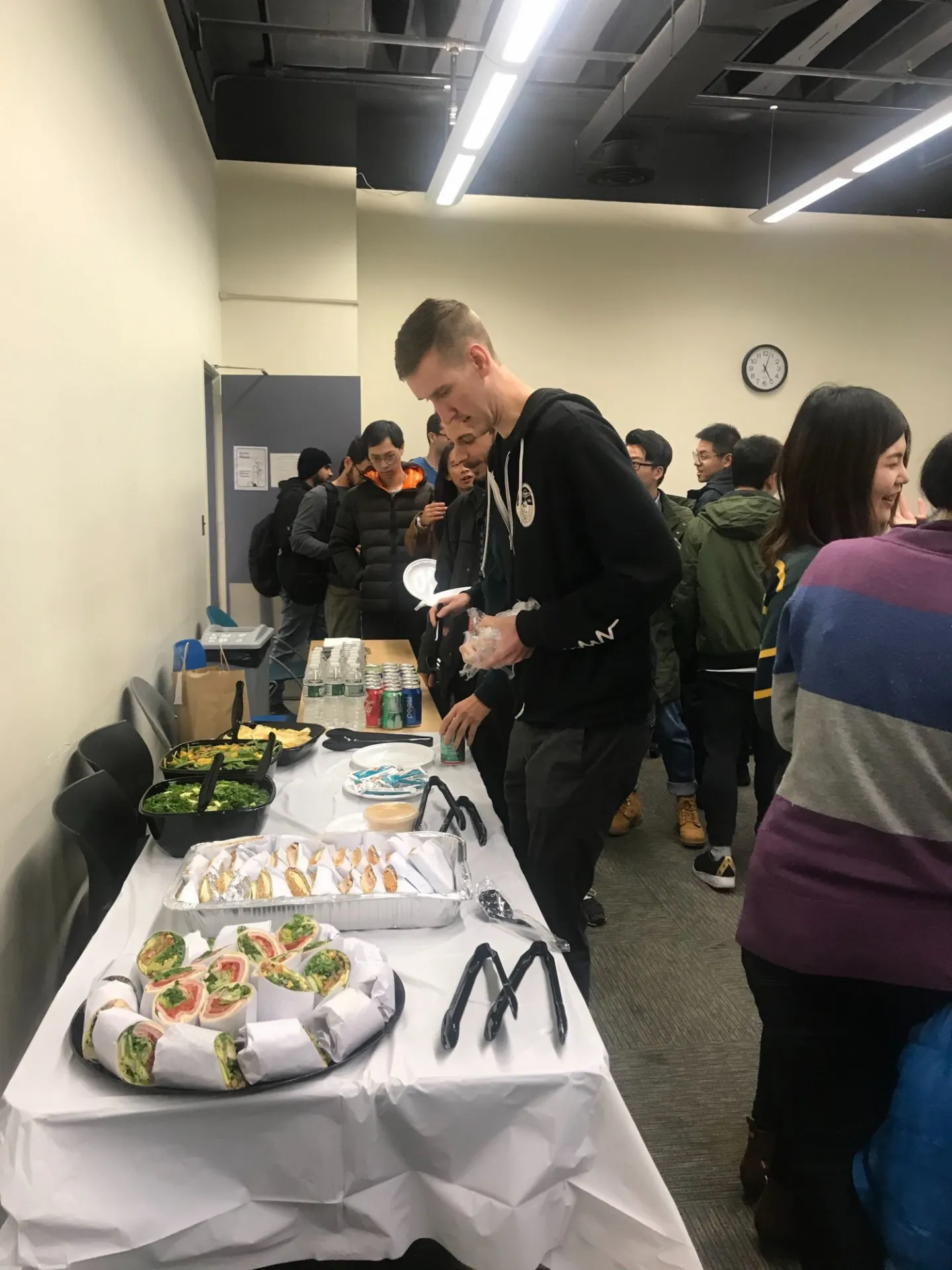 Students and panelists networking over refreshments before the panel discussion